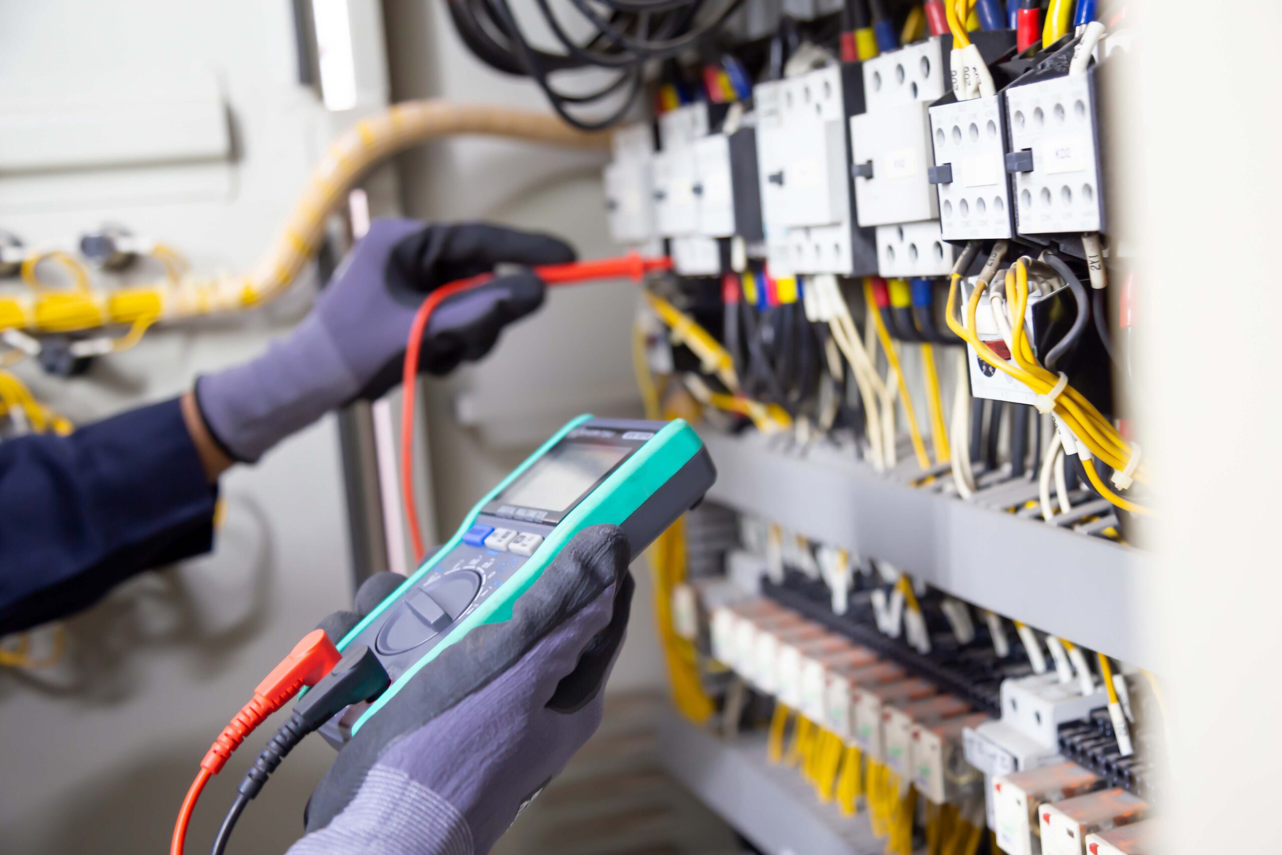 Electrician engineer tests electrical installations and wires on